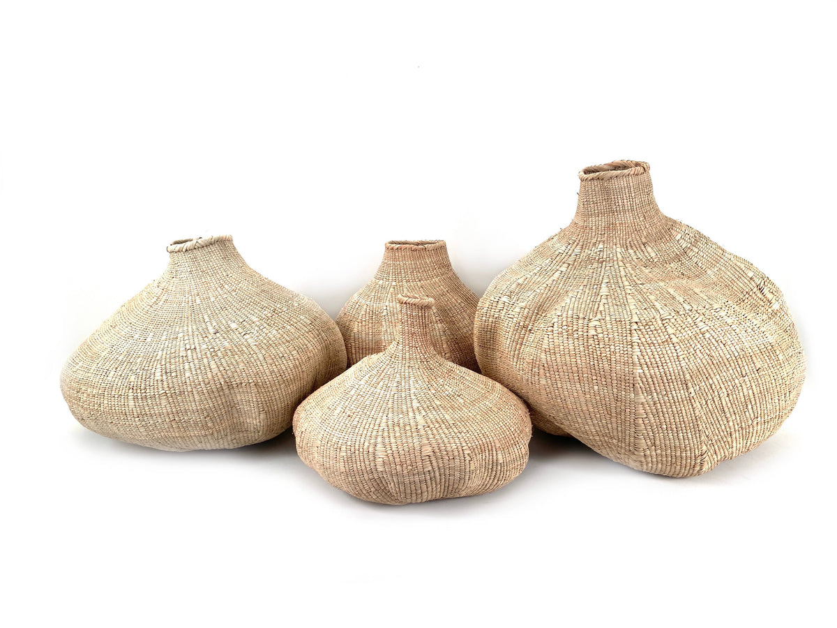 Set of four woven garlic baskets on a white background